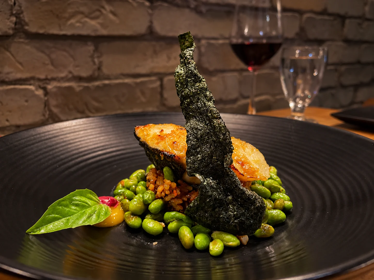 Miso-glazed black cod with garlic fried rice, sesame edamame and nori