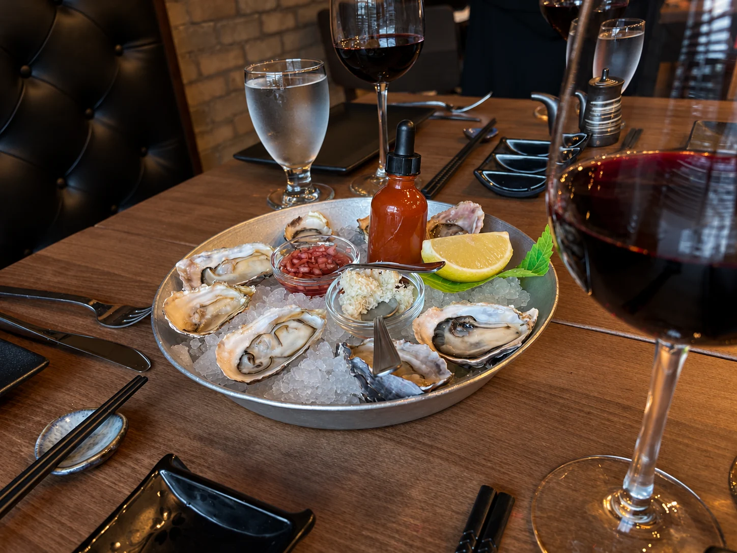 Fresh oysters on ice, with wine at the table