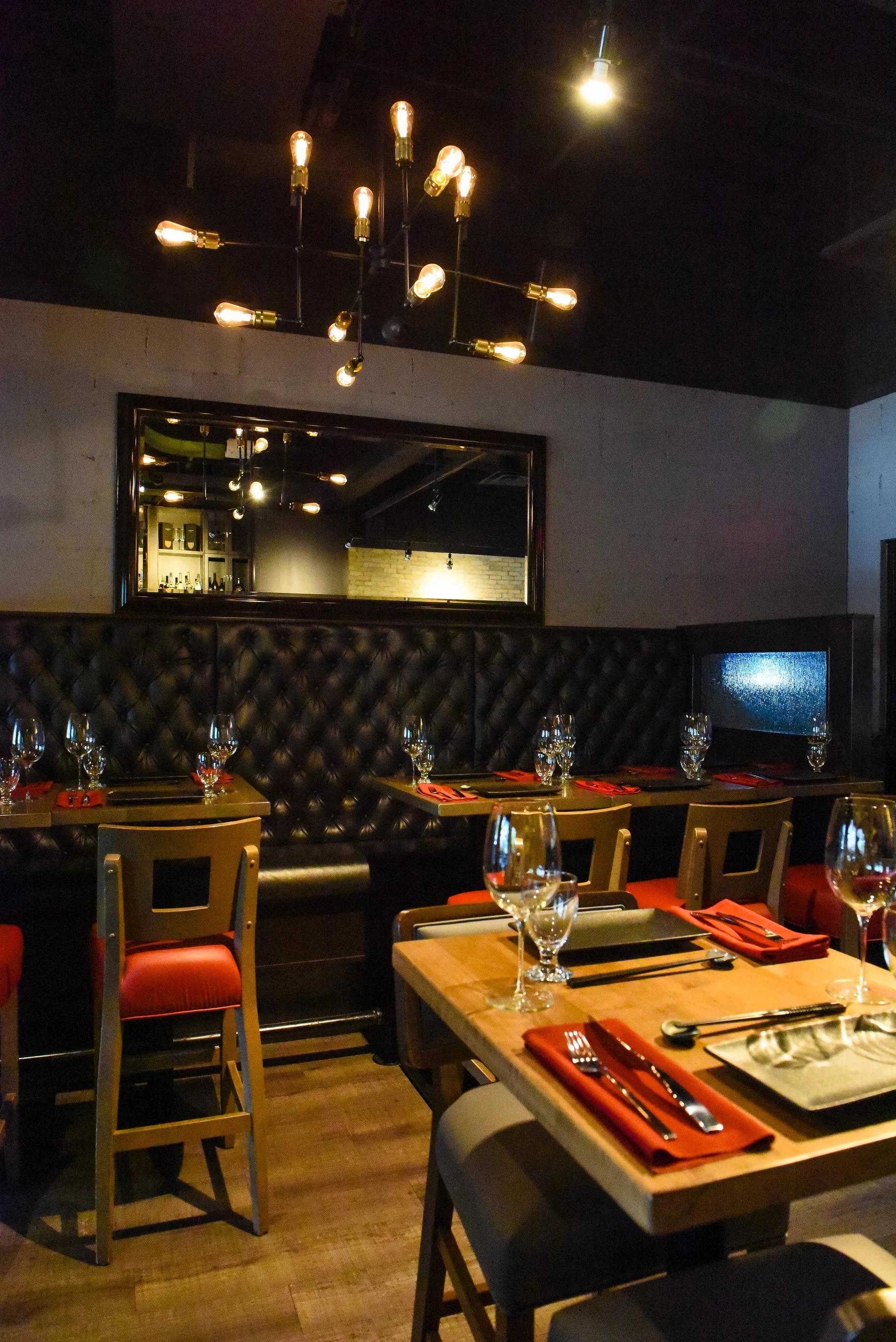 A warmly lit table and banquette at Prime
