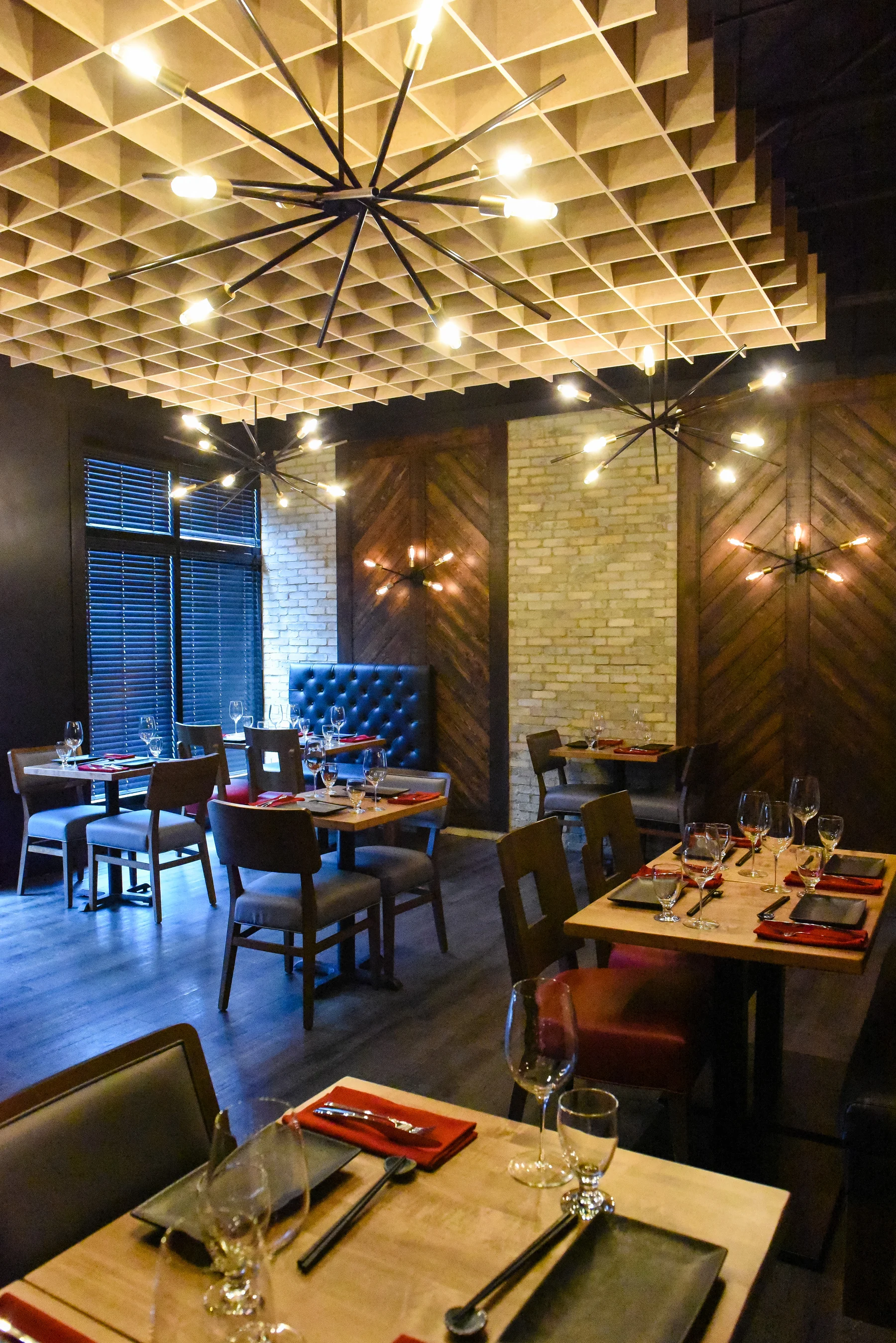 Tables set for dinner beneath Prime’s sculptural ceiling lights