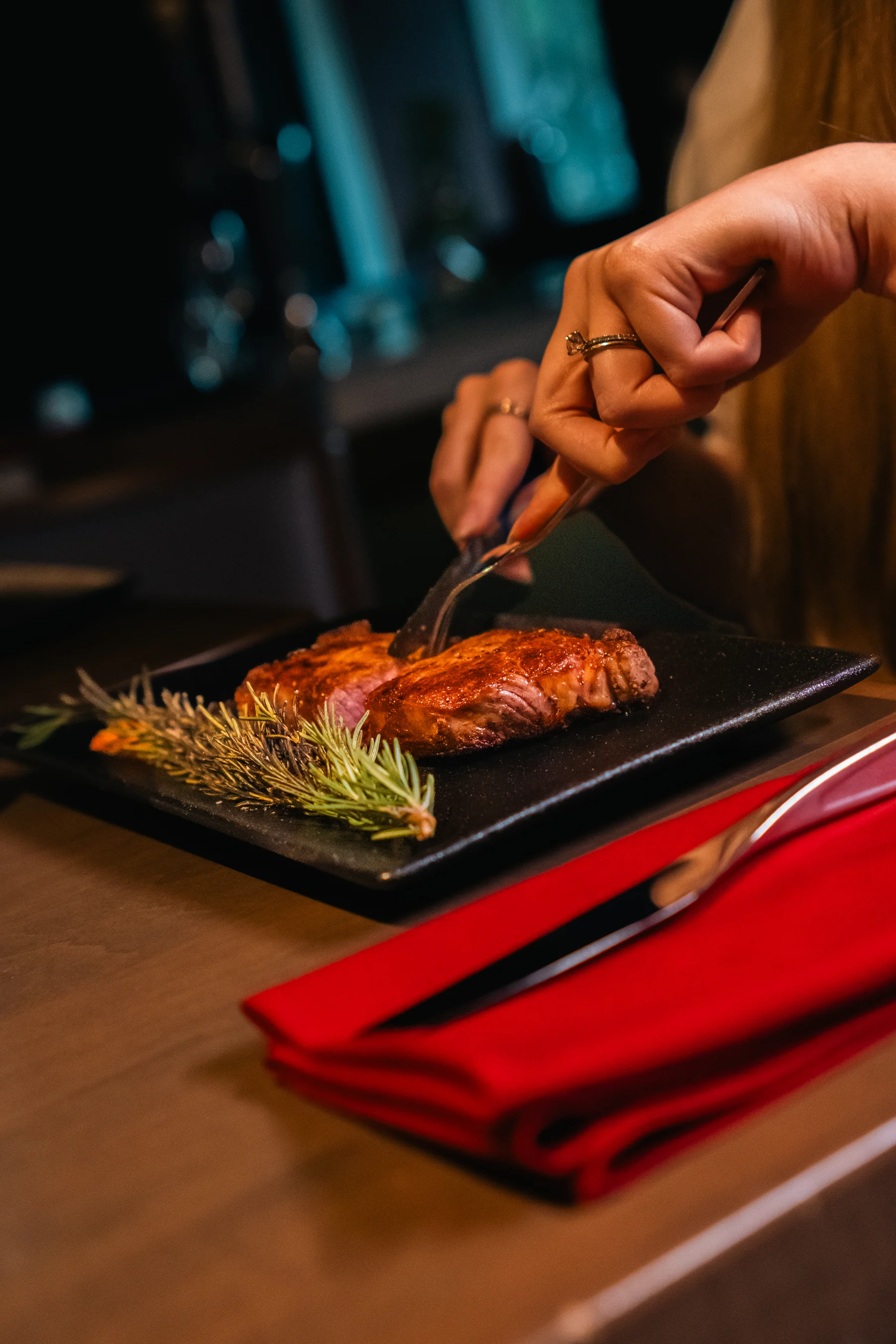A guest cuts into a steak at Prime