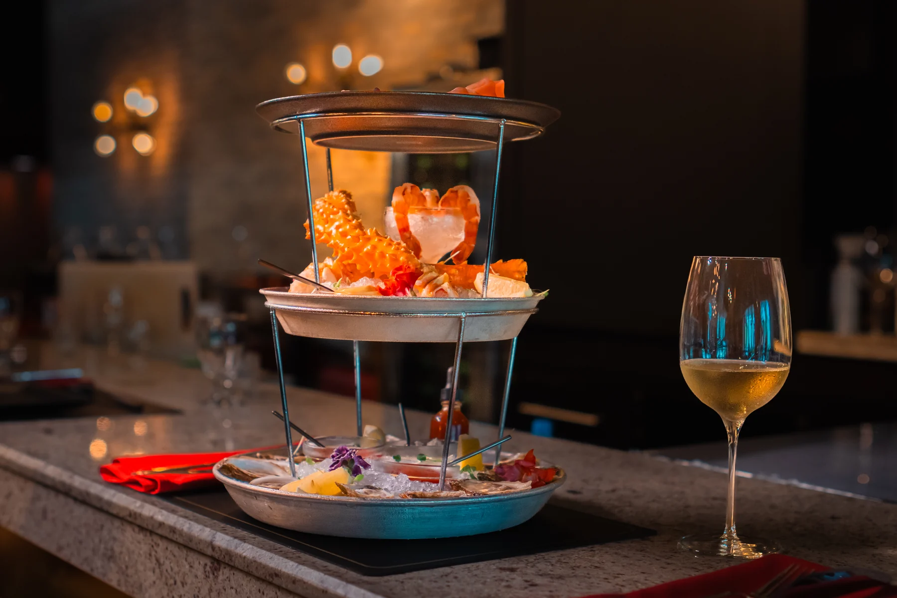 A raw bar tower and a glass of wine at Prime